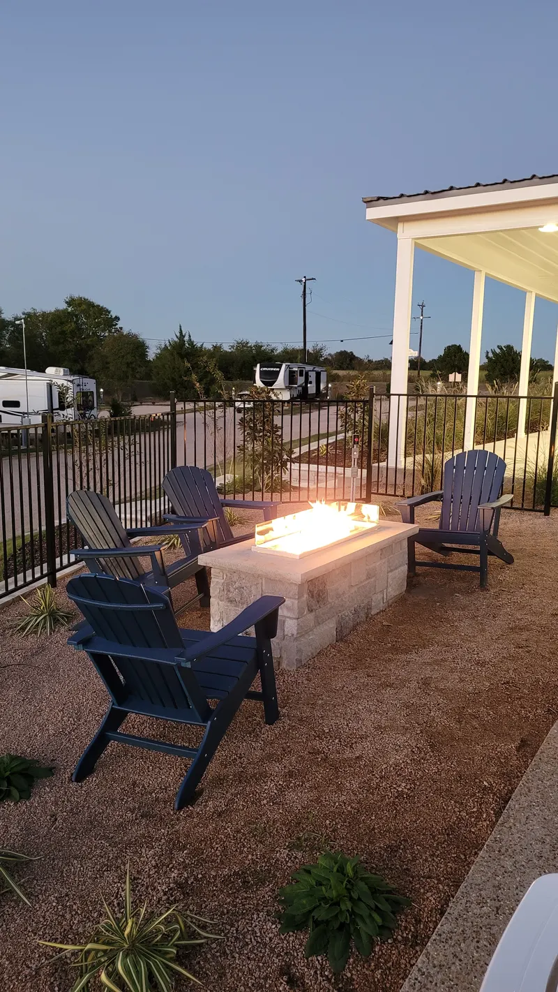 Outdoor TV and fire pit on the Farmhouse patio at dusk