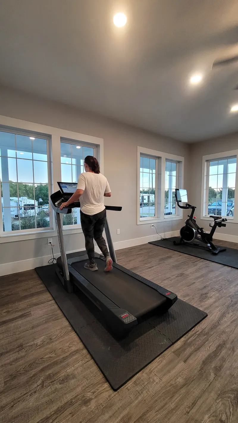 Fitness center with windows overlooking the resort