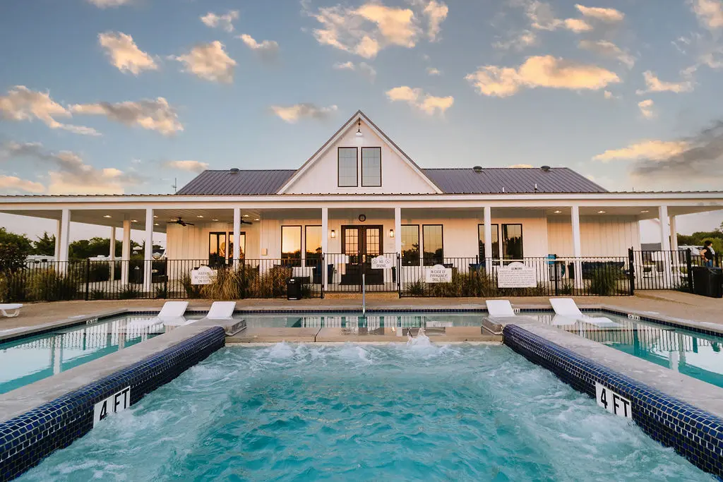 Pool, clubhouse, and patio nestled in greenery — your home base while you explore Anna, McKinney, and North Texas.