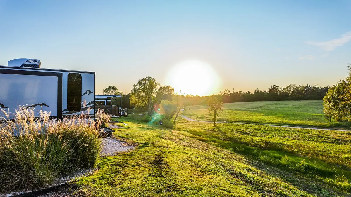 RV site at sunrise with meadow and ornamental grasses