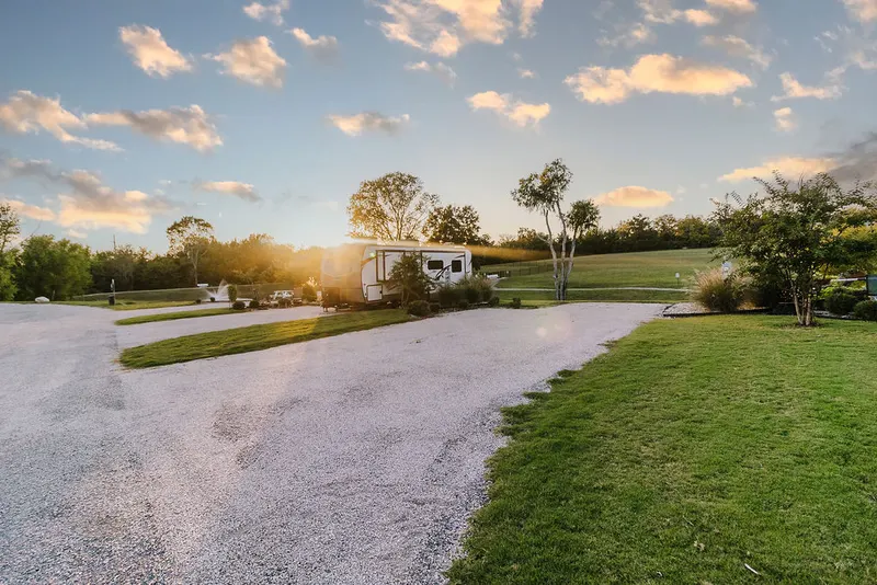 RV sites in a row at sunrise with meadow behind